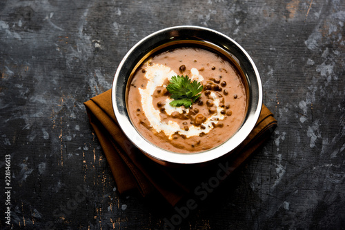 Dal makhani / makhni is a popular dish from India. Made with ingredients like whole black lentil, butter and cream. Served with Naan/roti and rice photo
