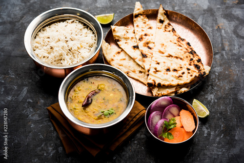 Dal Tadka Fry / Indian Lentil Curry served in a bowl with rice and roti, selective focus
