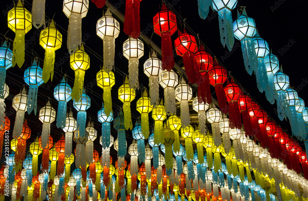 colorful hanging lanterns lighting on night sky in loy krathong festival at northern of thailand