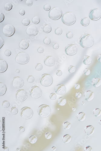 close-up view of transparent water drops on grey abstract background