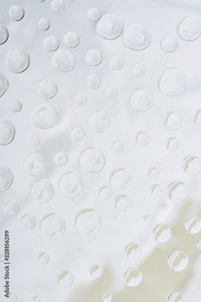 close-up view of transparent water drops on light abstract background