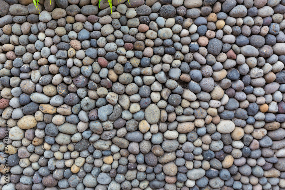 Background texture, wall consisting of small river stones Background texture, wall consisting of small river stones