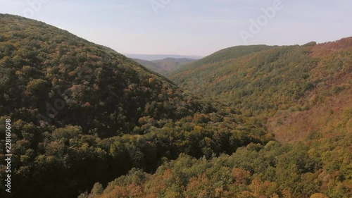Aerial view of mountains in national park Cheile Nerei Beusnita in Romania. Part of Carpathian mountains with beautiful autumn colors.
