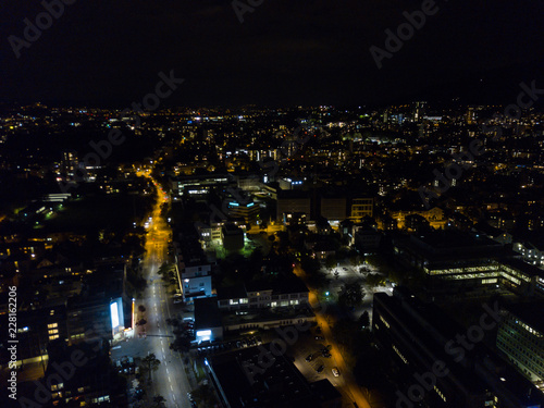 Aerial view of european city in night with bright lights and streets with cars