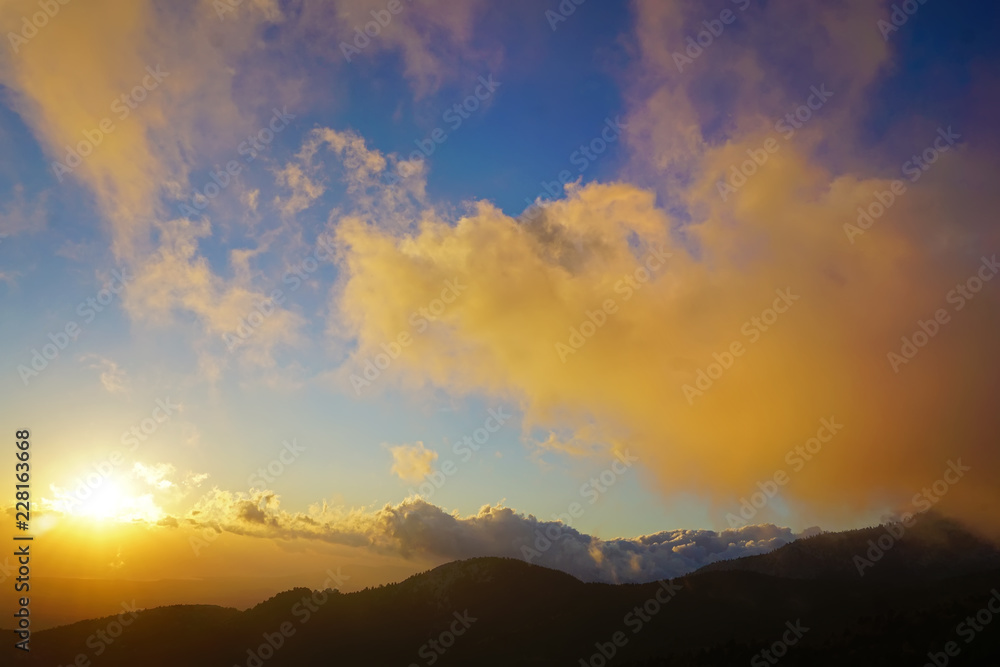 beautiful sunset with clouds over the mountains