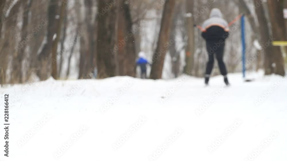 Man goes cross-country skiing in winter park Man goes cross-country skiing in winter park