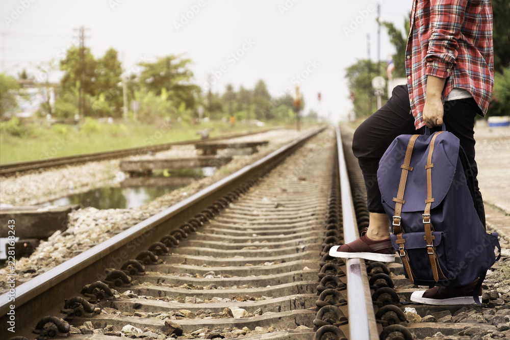 man standing and put his foot on the railway. Backpacker and Travel theme man standing and put his foot on the railway. Backpacker and Travel theme