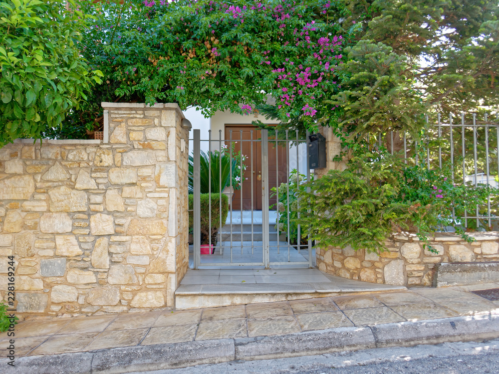 stone fence and vintage house main entrance, Athens Greece