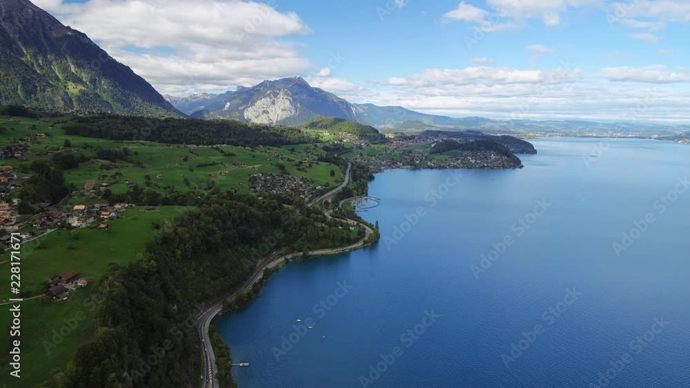 Aerial panoramic view of lake Thun (Thunersee), picturesque scenery of mountains (Bernese Alps), town of Spiez, late summer - landscape panorama of canton of Bern from above, Switzerland, Europe