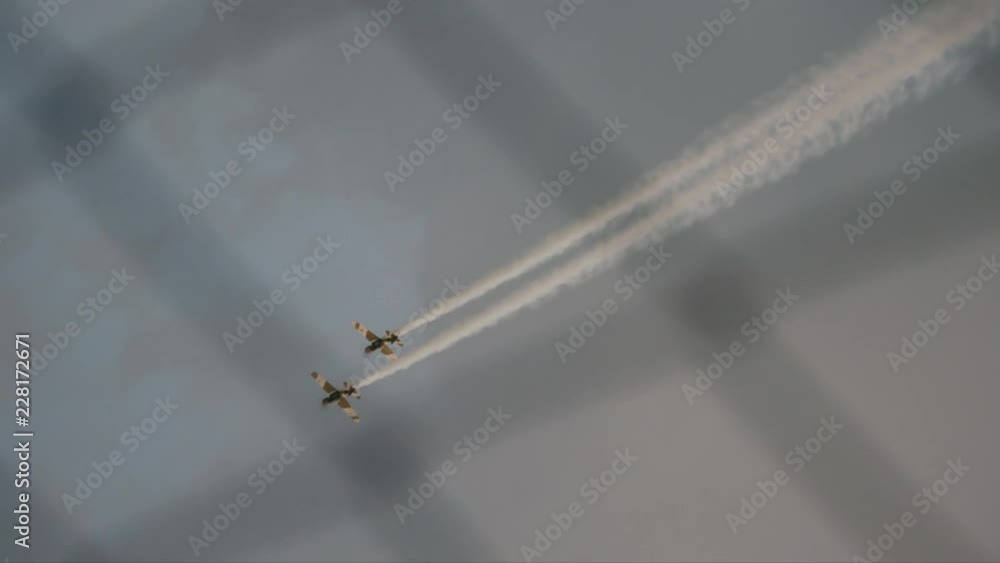 Two airplanes show. View through wire fence. Descending Two airplanes show. View through wire fence. Descending
