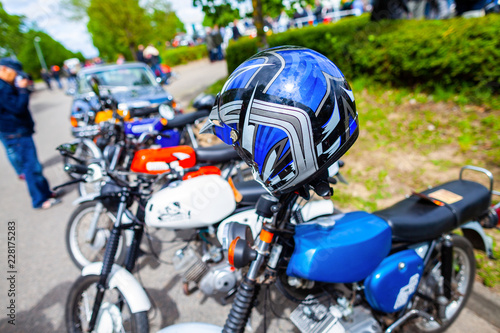 Blue helmet hangs on a german motorbike