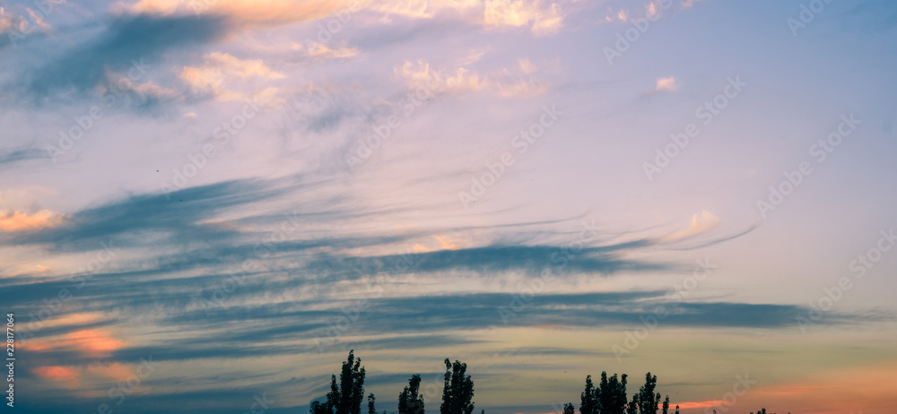 Fototapeta premium Landscape with dramatic light - beautiful golden sunset with saturated sky and clouds.