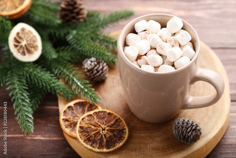 Cappuccino with marshmallows in cup and fir tree branches on wooden table Cappuccino with marshmallows in cup and fir tree branches on wooden table