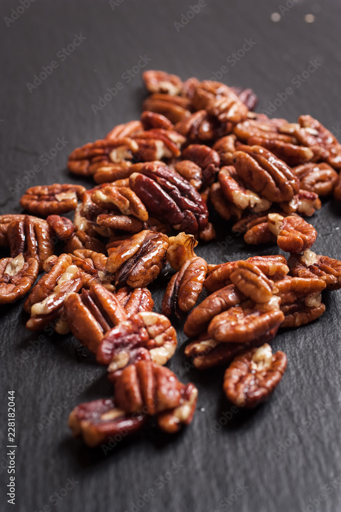 Heap of Pecan Nuts (selective focus) on an slate