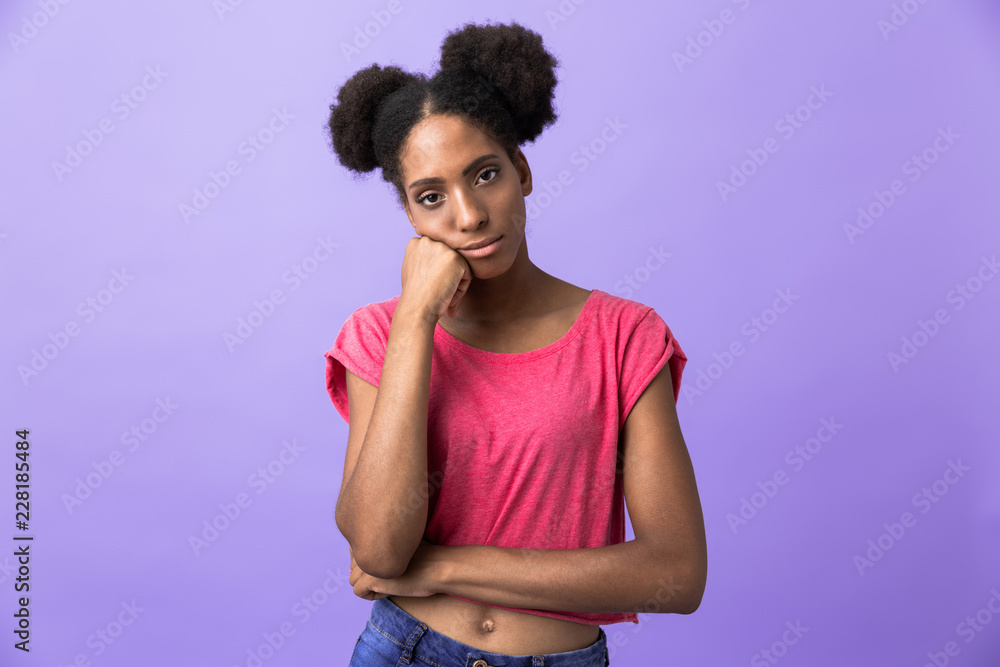 Photo of displeased african american woman propping up head, isolated over violet background