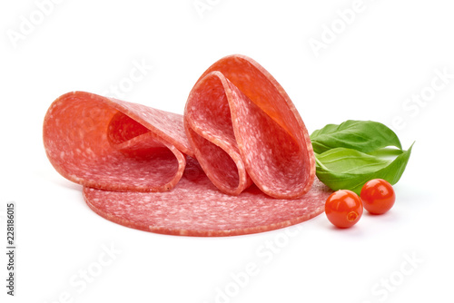 Turkey smoked salami with basil leaves and Physalia berries, close-up, isolated on a white background photo
