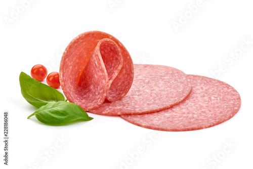 Sausage for pizza with basil leaves and Physalia berry. Isolated on white background. Close-up. photo