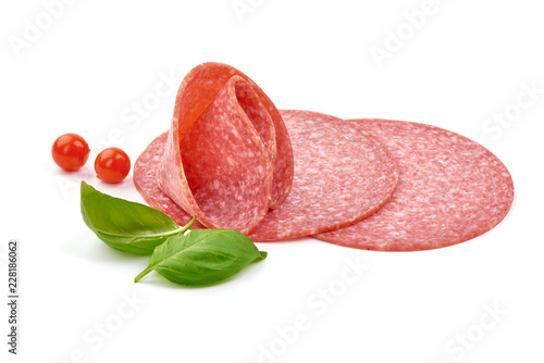 Sausage for pizza with basil leaves and Physalia berry. Isolated on white background. Close-up. photo