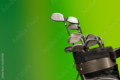 Different golf clubs on background.