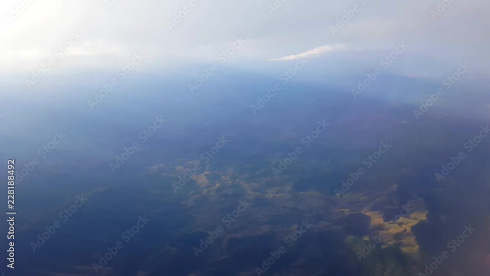 Scene from the state of Espirito Santo seen from the window of an airplane. The plane crosses some clouds. Mountains and vegetation below. Scene from the state of Espirito Santo seen from the window of an airplane. The plane crosses some clouds. Mountains and vegetation below.