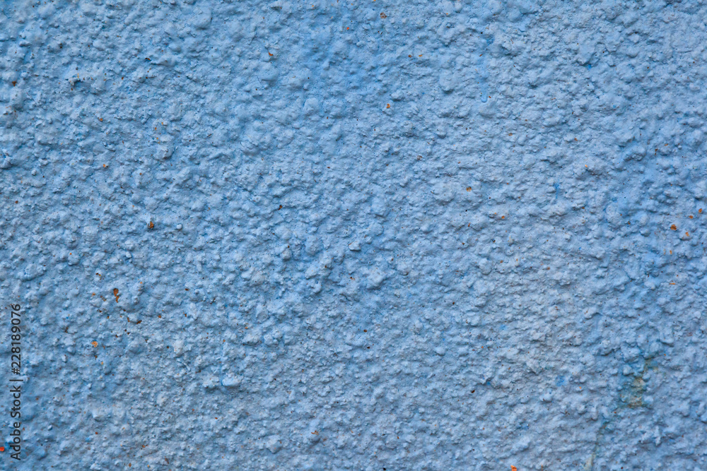 The texture of the blue plastered facing of the stone surface of the wall background. The texture of the blue plastered facing of the stone surface of the wall background.