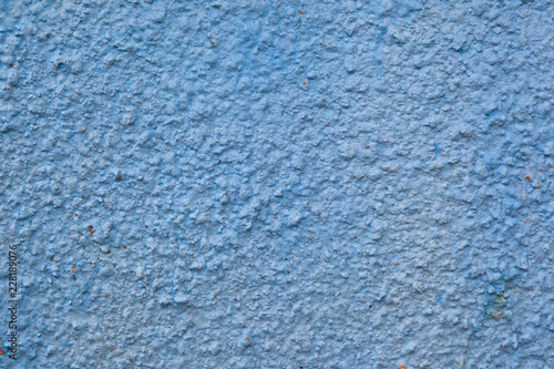 The texture of the blue plastered facing of the stone surface of the wall background.