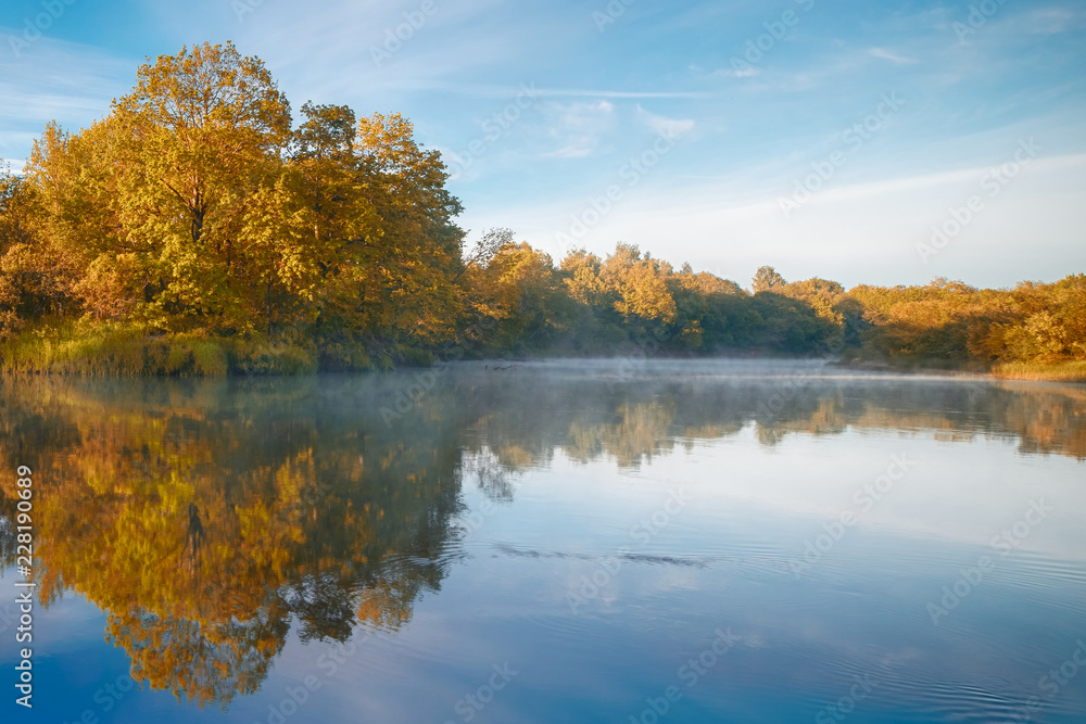Symmetry reflection on the autumn river. Sunrise. Symmetry reflection on the autumn river. Sunrise.