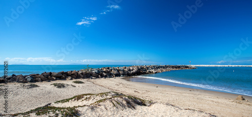 Foto Ventura beach and sea rock wall jetty on the California coastline USA
