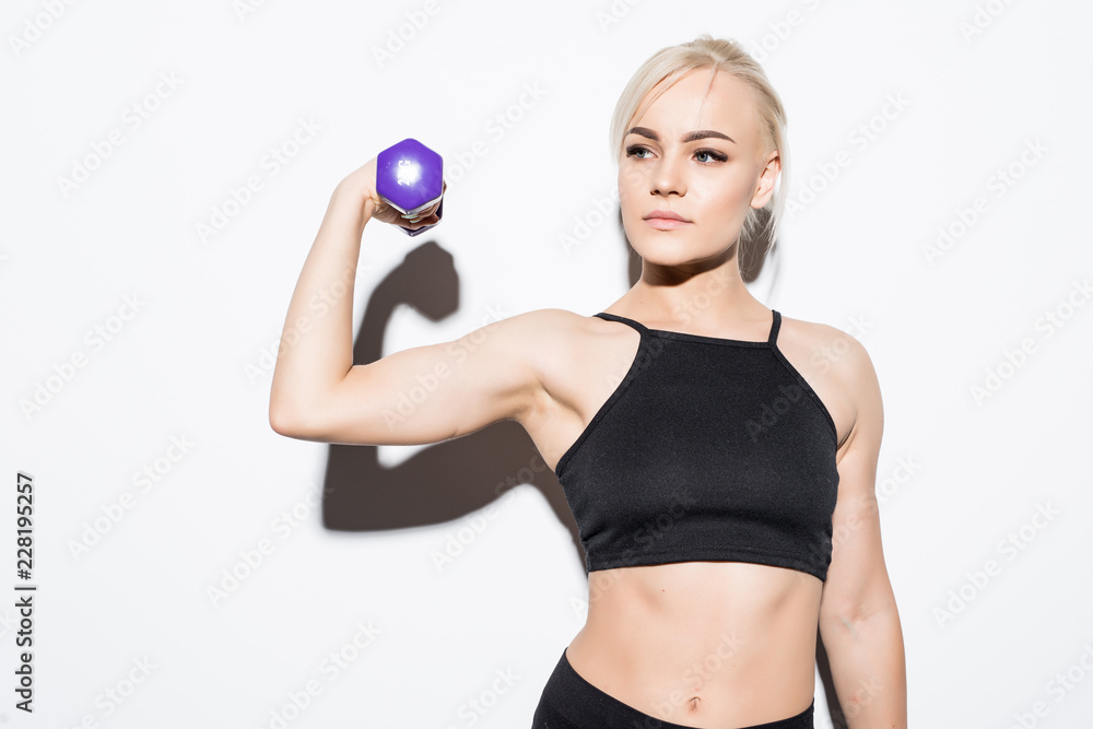 Portrait of young beautiful woman making physical exercises with dumbbells isolated on white background Portrait of young beautiful woman making physical exercises with dumbbells isolated on white background