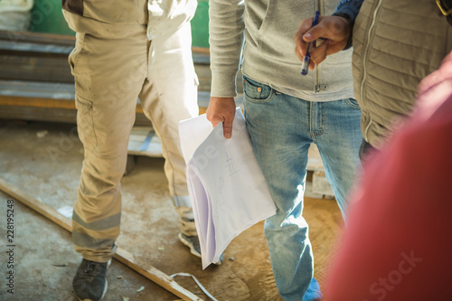 construction team discusses drawing documentation