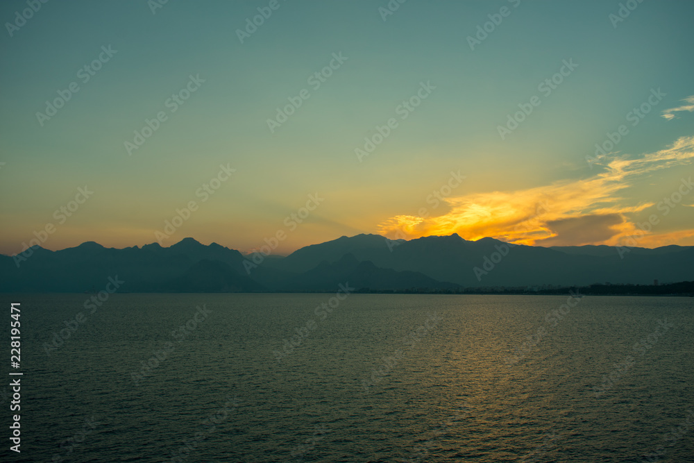 beautiful sunset above sea and taurus mountains in Antalya, Turkey