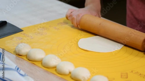 Woman roll out the dough on the table. Step by step recipe of homemade tortillas. photo