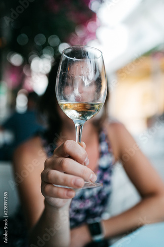 Woman's hands holding a glass of white wine