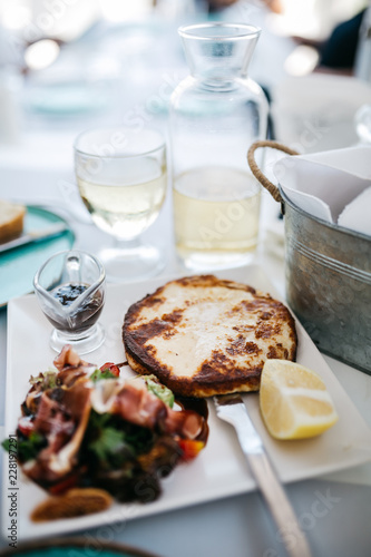 Wallpaper Mural Traditional grilled cheese with salad and slice of lemon on white plate Torontodigital.ca