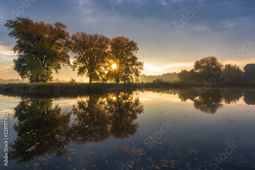 Fototapeta Naklejka Na Ścianę i Meble -  Sunrise over the pond at autumn in Falenty near Raszyn, Masovia, Poland