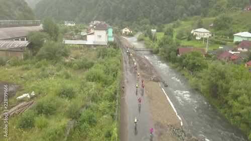 Aerial view of Tura Cu Copaci cycling race in Colibita, Romania with drone flying forward photo