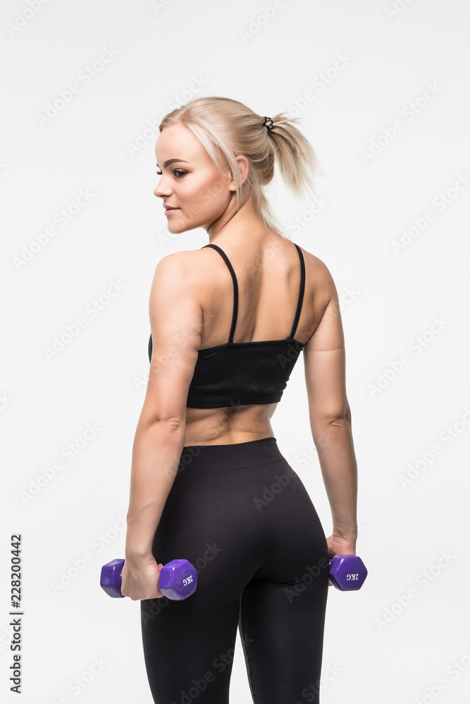 Fototapeta premium portrait of pretty sporty woman holding weights isolated on gray background