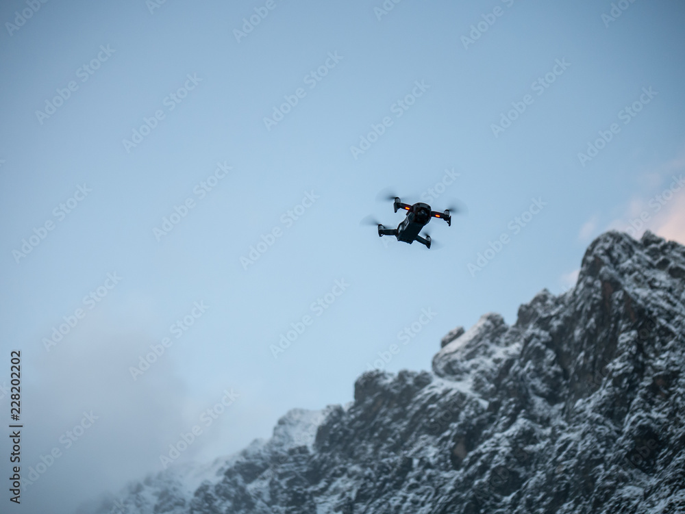 Drone hovering against Blue sky. Drone hovering against Blue sky.