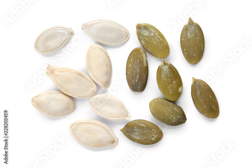 Raw pumpkin seeds on white background, top view
