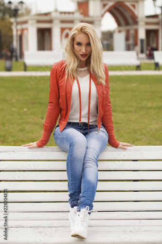 Young beautiful blonde woman in red jacket © Andrey_Arkusha