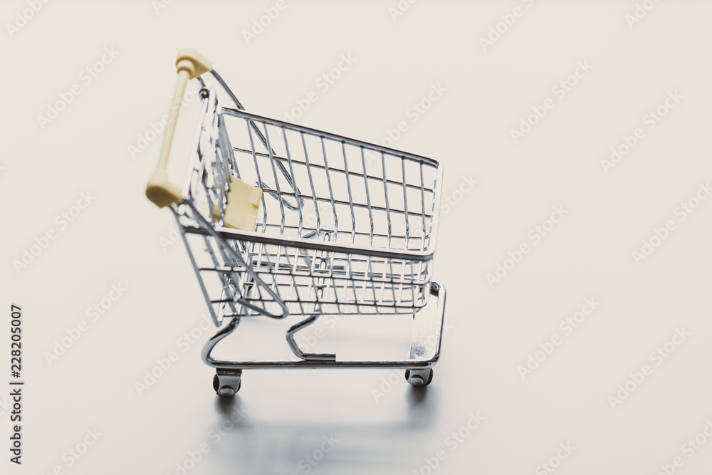 Self-service supermarket shopping little trolley cart on white background Self-service supermarket shopping little trolley cart on white background