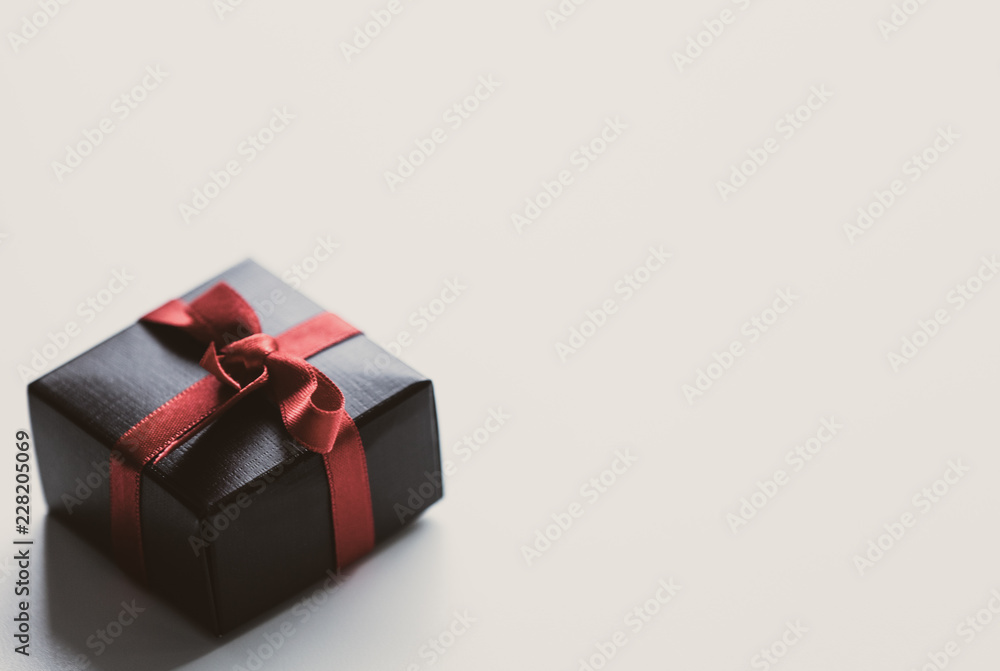 Fototapeta premium Little gift box on white glass background