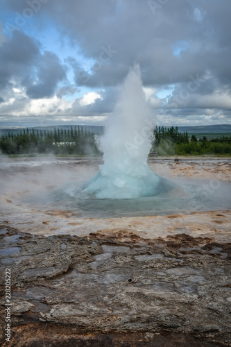 Eruption of Strokkur geyser in Iceland in summer -close-up