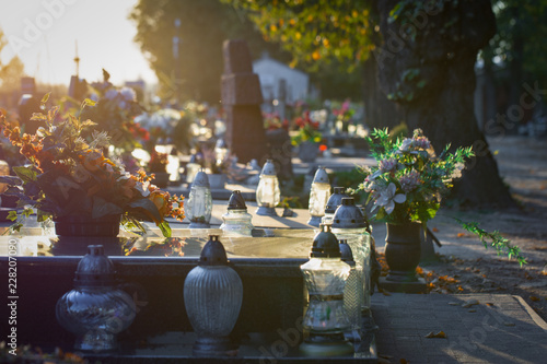 Fotografie Flowers and candles on a colorful polish cemetery
