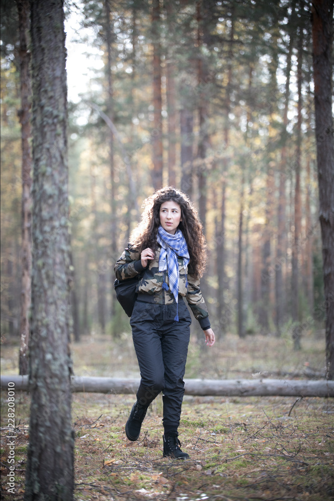 Portrait of happy woman with curly hair in an autumn. Young woman having fun in the sunny fall park. Portrait of happy woman with curly hair in an autumn. Young woman having fun in the sunny fall park.