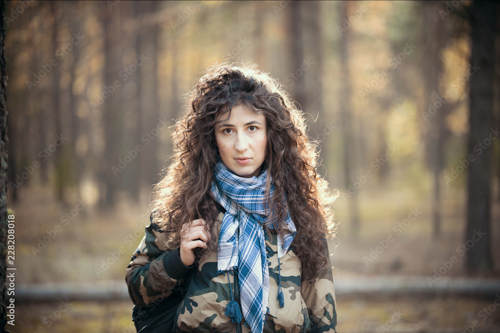 Portrait of happy woman with curly hair in an autumn. Joyful young woman having fun in the sunny fall park. Portrait of happy woman with curly hair in an autumn. Joyful young woman having fun in the sunny fall park.
