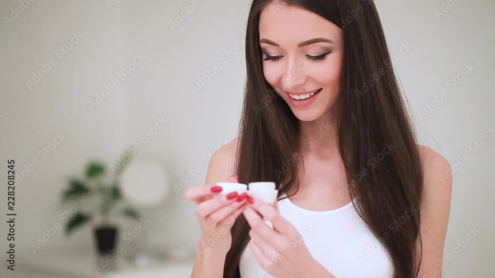 Concept Of Skincare. The Portrait Of Young Woman With Perfect Skin Applying a Day, Night Cream On Her Previously Cleansed Face Concept Of Skincare. The Portrait Of Young Woman With Perfect Skin Applying a Day, Night Cream On Her Previously Cleansed Face