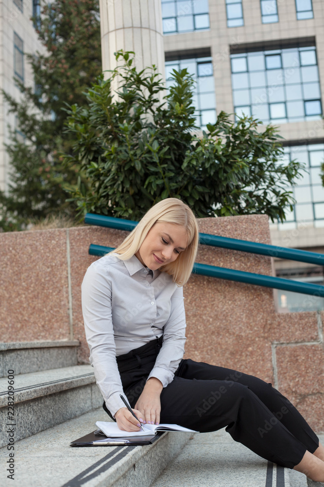 Woman holding and filling papers during lunch break. Woman holding and filling papers during lunch break.