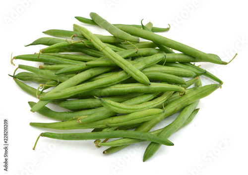 small and slender green beans (haricot vert) on a white background
