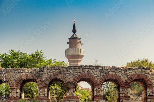 Minaret behind City walls of Constantinople in Istanbul photo